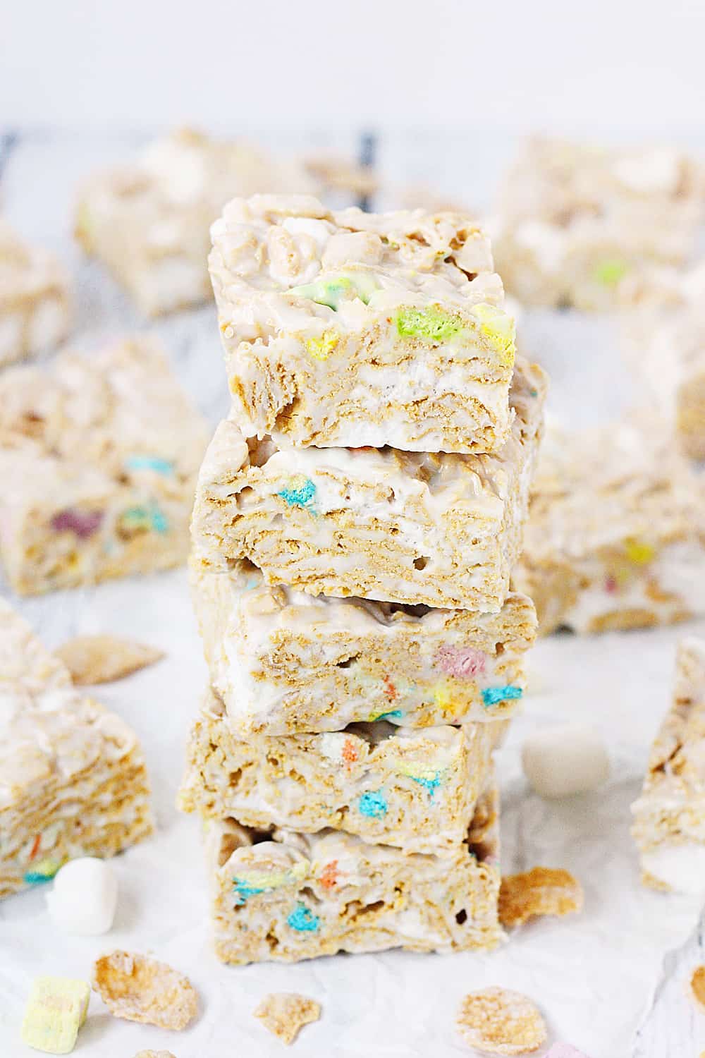 Lucky Charms Frosted Flakes Marshmallow Treats -- You'll think you've died and gone to heaven when you taste these Lucky Charms Frosted Flakes marshmallow treats. They're extra marshmallowy, buttery, and white chocolaty! | halfscratched.com