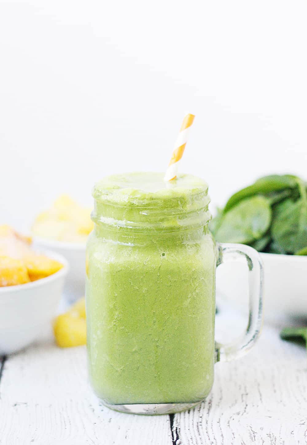 Pineapple Peach Green Smoothie -- This pineapple peach green smoothie is packed with good-for-you ingredients and good-for-your-taste-buds flavor. Frozen pineapple and peaches make it sweet while spinach and protein make it extra healthy! | halfscratched #ad #smoothie #recipe #drink