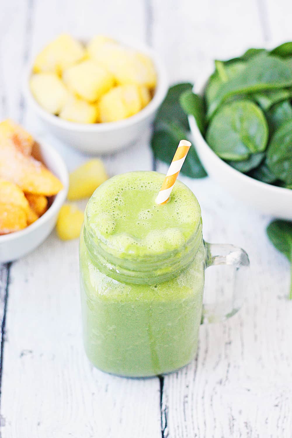 Pineapple Peach Green Smoothie -- This pineapple peach green smoothie is packed with good-for-you ingredients and good-for-your-taste-buds flavor. Frozen pineapple and peaches make it sweet while spinach and protein make it extra healthy! | halfscratched #ad #smoothie #recipe #drink