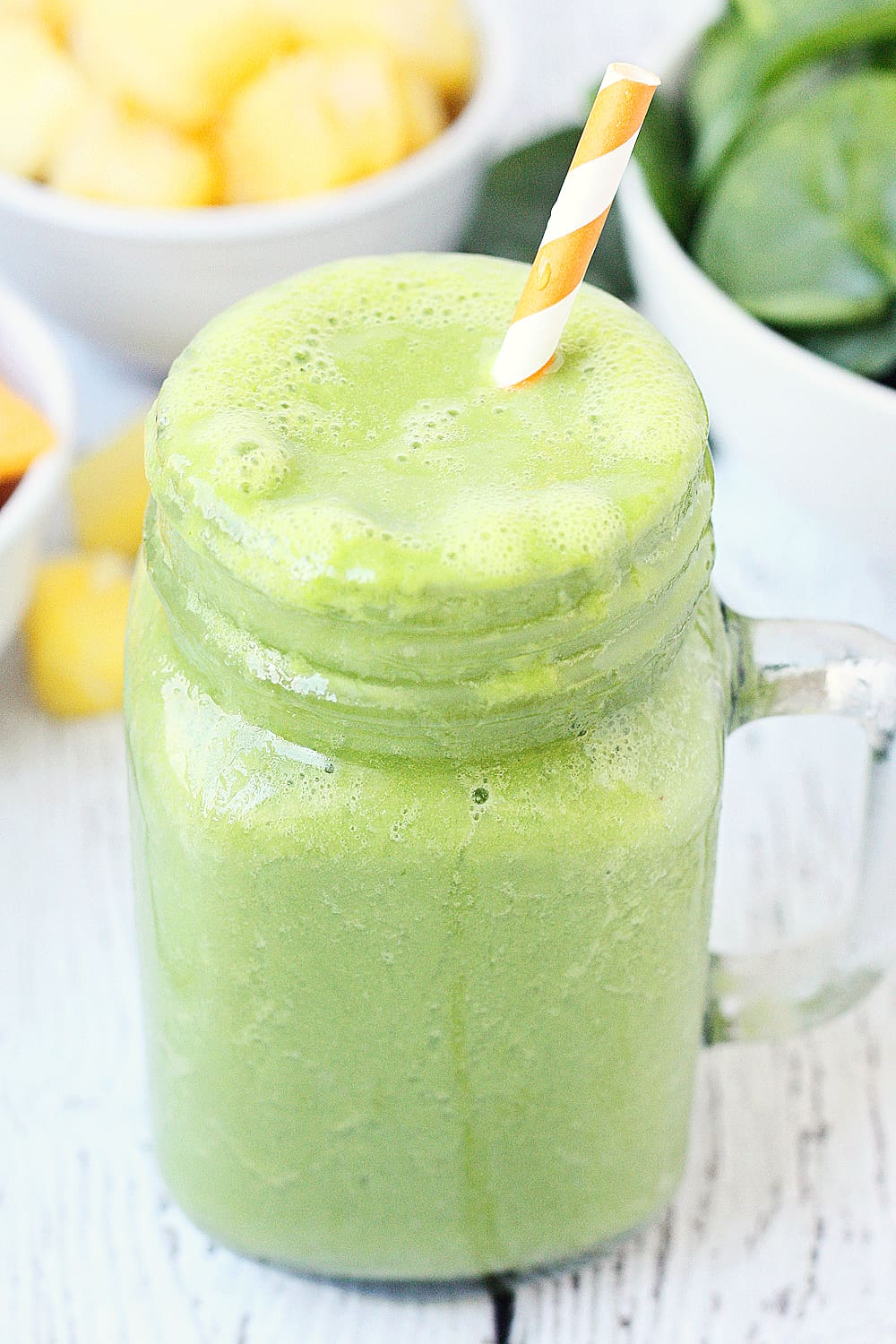 Pineapple Peach Green Smoothie -- This pineapple peach green smoothie is packed with good-for-you ingredients and good-for-your-taste-buds flavor. Frozen pineapple and peaches make it sweet while spinach and protein make it extra healthy! | halfscratched #ad #smoothie #recipe #drink