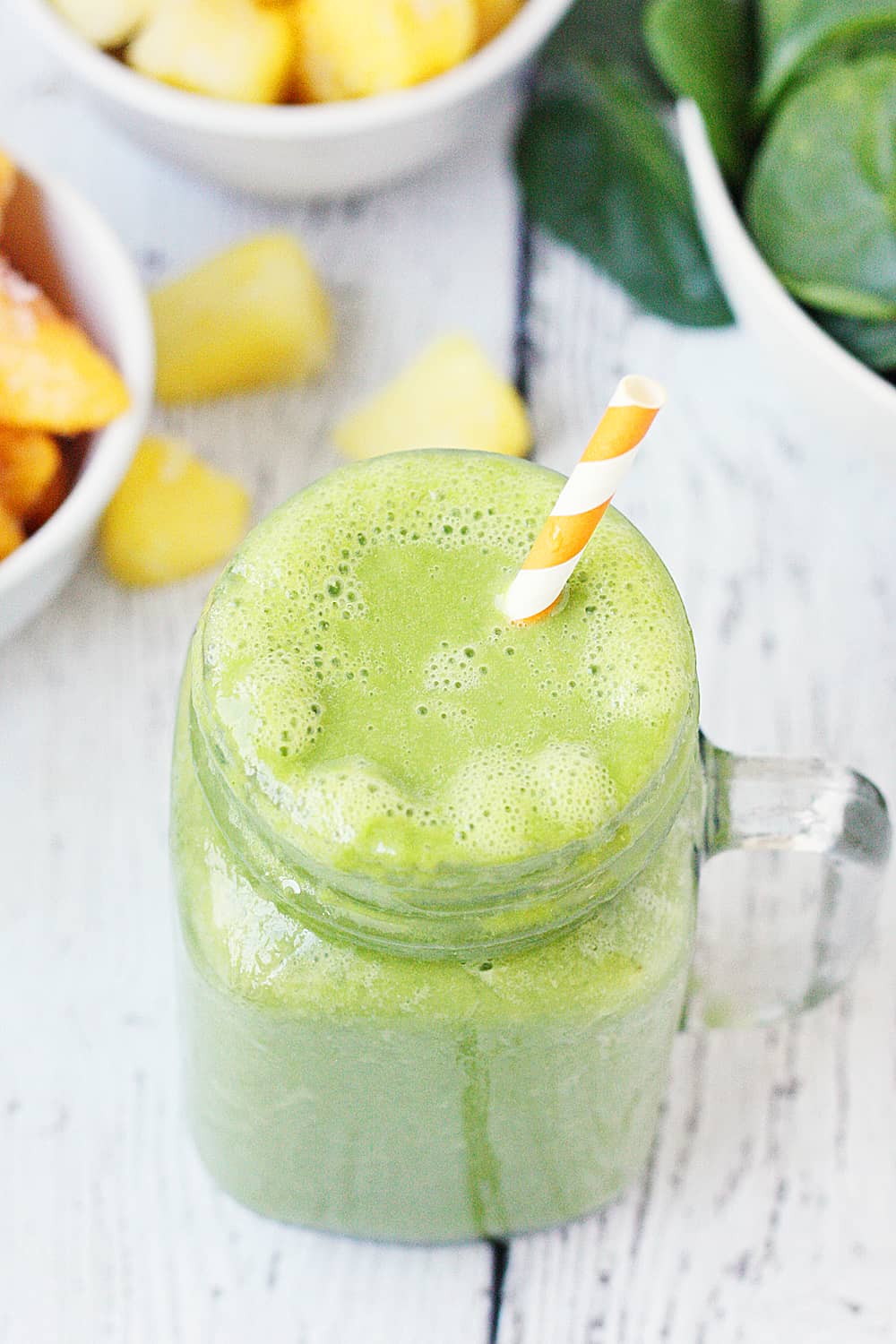 Pineapple Peach Green Smoothie -- This pineapple peach green smoothie is packed with good-for-you ingredients and good-for-your-taste-buds flavor. Frozen pineapple and peaches make it sweet while spinach and protein make it extra healthy! | halfscratched #ad #smoothie #recipe #drink