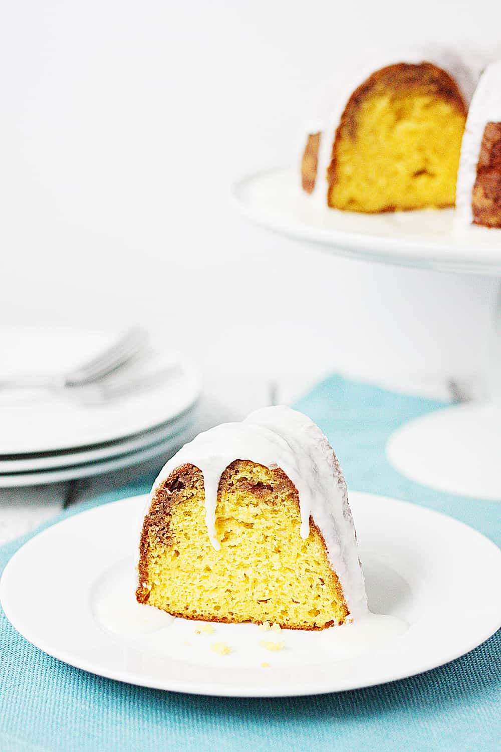 Slice of cake mix coffee cake bundt cake with full cake in the background