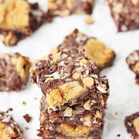 Double Peanut Butter Coconut Brownies -- Tempt your taste buds with these double peanut butter coconut brownies. Fudgy brownie mix is topped with peanut butter chocolate chip cookie dough, flaked coconut, chocolate chips, and peanut butter chips. | halfscratched.com