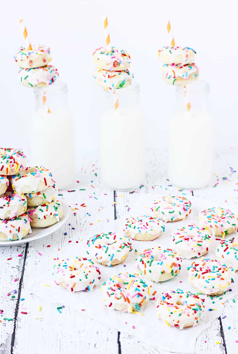 Mini Funfetti Cake Mix Donuts with Vanilla Glaze --Mini funfetti cake mix donuts are the perfect party treat! Topped with a vanilla glaze and colorful sprinkles, these mini donuts from cake mix are not only super cute but also super easy! #donuts #doughnut #cakemix #dessert #funfetti #bakeddonuts #recipe #dessert #cakemixrecipe 