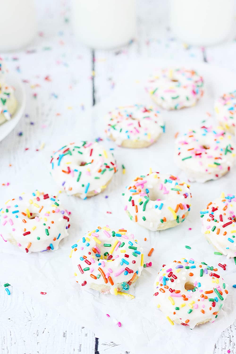Mini Funfetti Cake Mix Donuts with Vanilla Glaze --Mini funfetti cake mix donuts are the perfect party treat! Topped with a vanilla glaze and colorful sprinkles, these mini donuts from cake mix are not only super cute but also super easy! #donuts #doughnut #cakemix #dessert #funfetti #bakeddonuts #recipe #dessert #cakemixrecipe