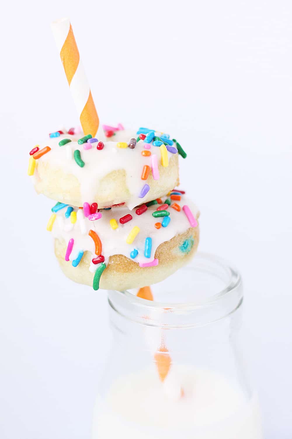 Mini Funfetti Cake Mix Donuts with Vanilla Glaze --Mini funfetti cake mix donuts are the perfect party treat! Topped with a vanilla glaze and colorful sprinkles, these mini donuts from cake mix are not only super cute but also super easy! #donuts #doughnut #cakemix #dessert #funfetti #bakeddonuts #recipe #dessert #cakemixrecipe 