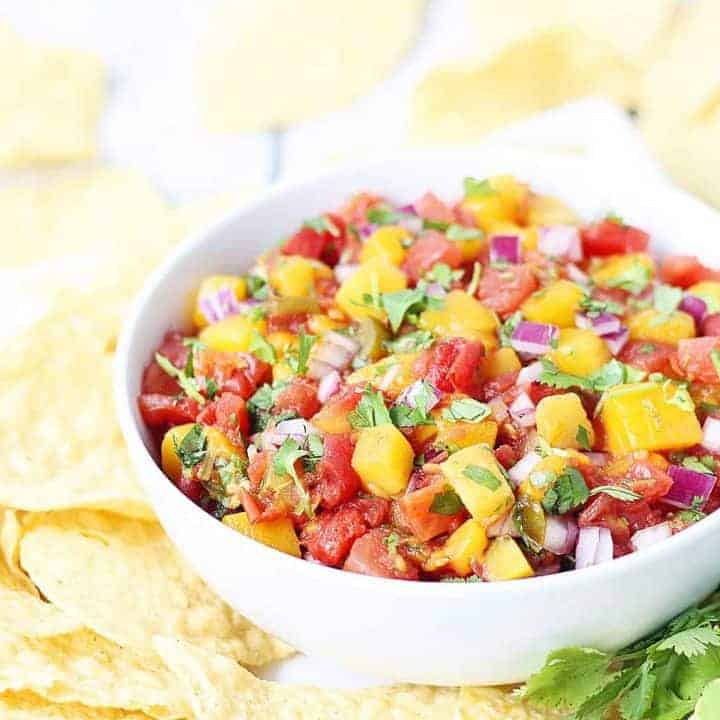 Easy Mango Salsa -- This easy mango salsa recipe comes together in about five minutes and requires only a handful of ingredients. You can serve it immediately, which makes it a great last-minute Cinco de Mayo appetizer! #salsa #appetizer #cincodemayo #mexicanrecipe #mexican #mango #easyrecipe #halfscratched