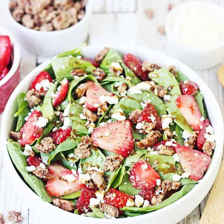 Strawberry Spinach Salad with Balsamic Poppy Seed Dressing -- This strawberry spinach salad boasts baby spinach, fresh strawberries, candied pecans, feta cheese, and the most amazing balsamic poppy seed dressing!