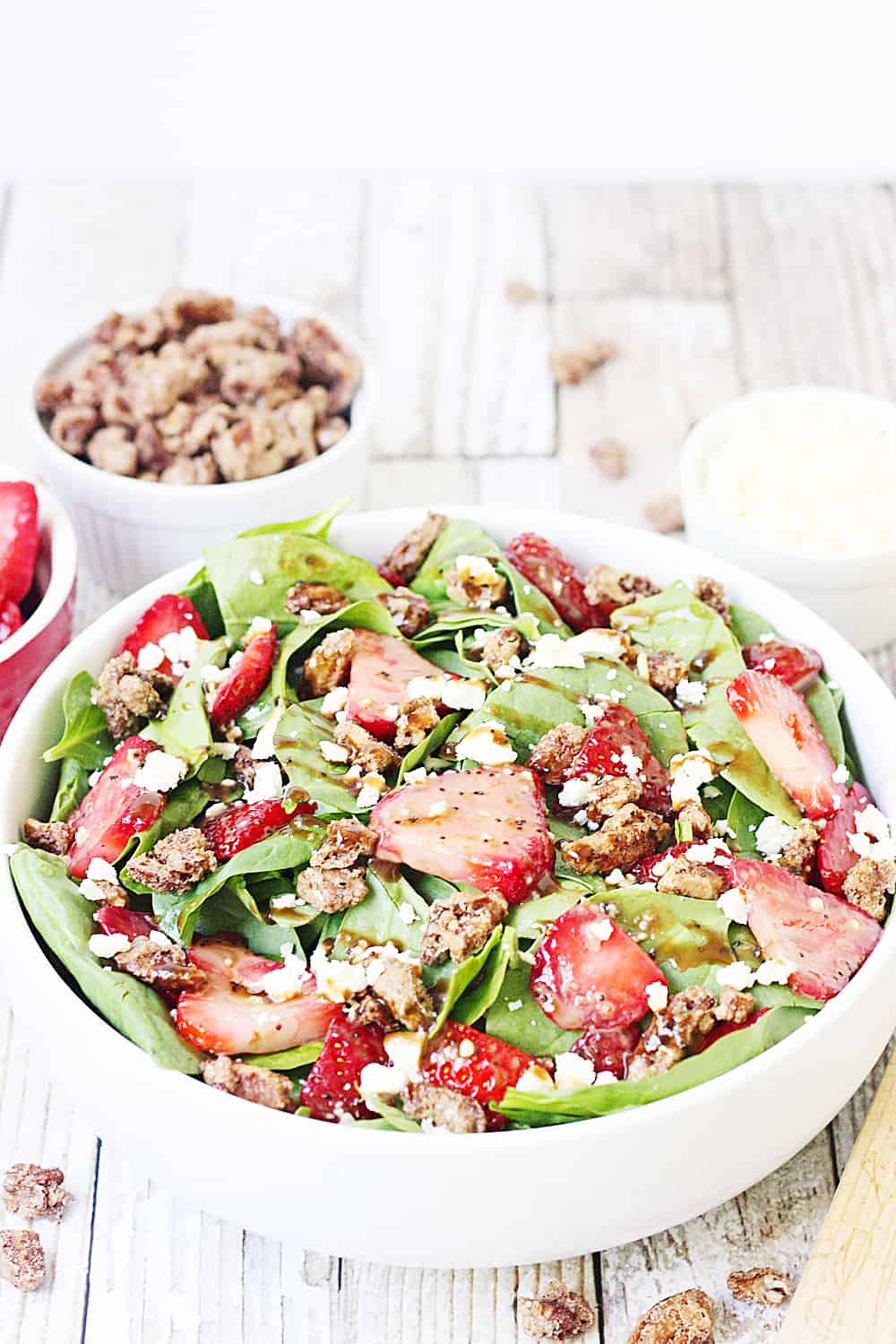 Strawberry Spinach Salad with Balsamic Poppy Seed Dressing -- This strawberry spinach salad boasts baby spinach, fresh strawberries, candied pecans, feta cheese, and the most amazing balsamic poppy seed dressing!