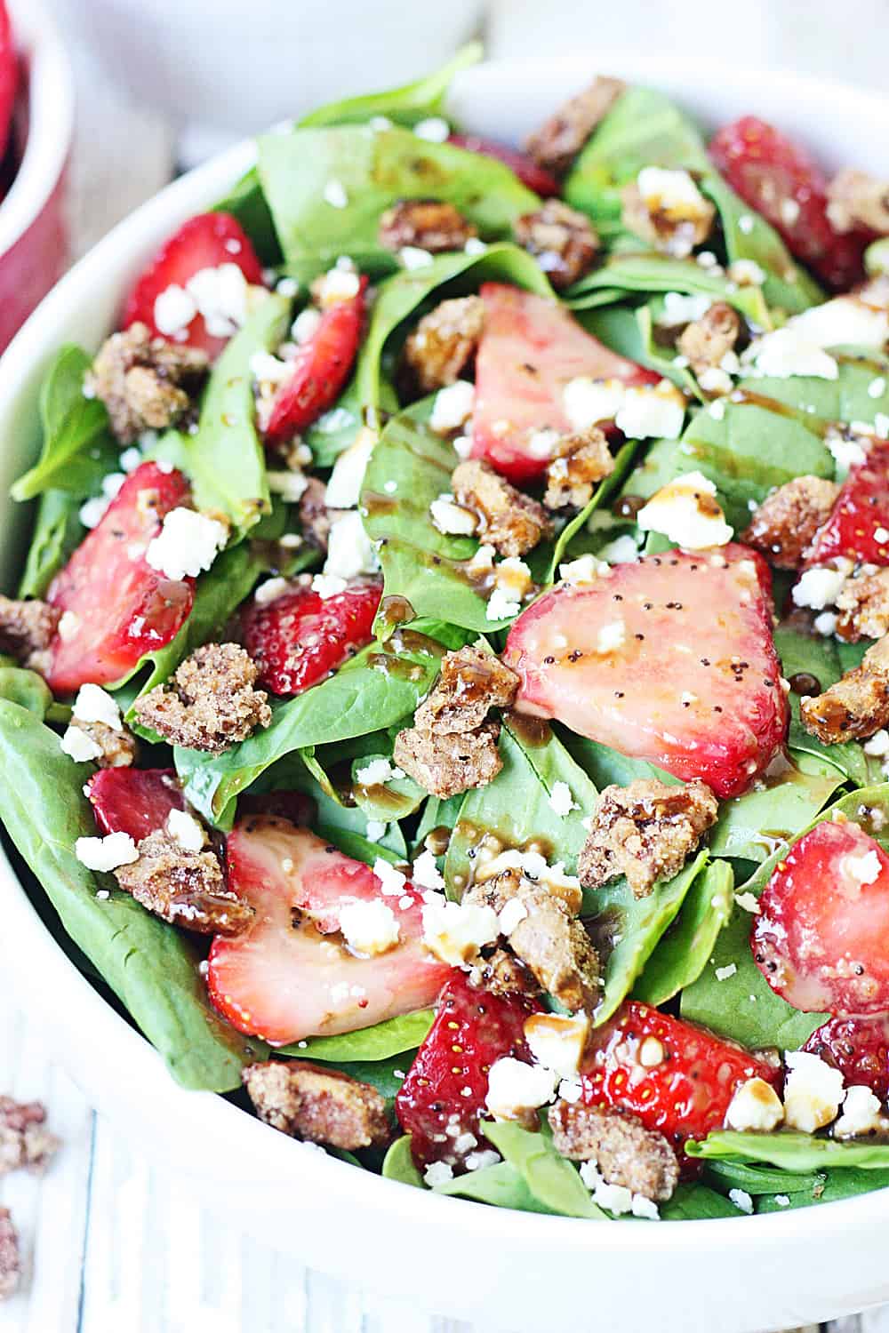 Strawberry Spinach Salad with Balsamic Poppy Seed Dressing -- This strawberry spinach salad boasts baby spinach, fresh strawberries, candied pecans, feta cheese, and the most amazing balsamic poppy seed dressing!