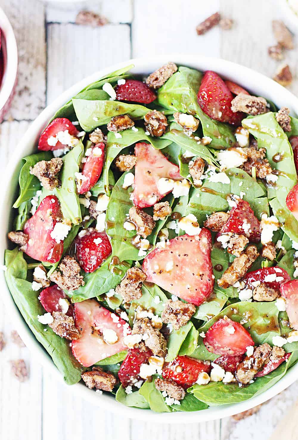 Strawberry Spinach Salad with Balsamic Poppy Seed Dressing -- This strawberry spinach salad boasts baby spinach, fresh strawberries, candied pecans, feta cheese, and the most amazing balsamic poppy seed dressing!