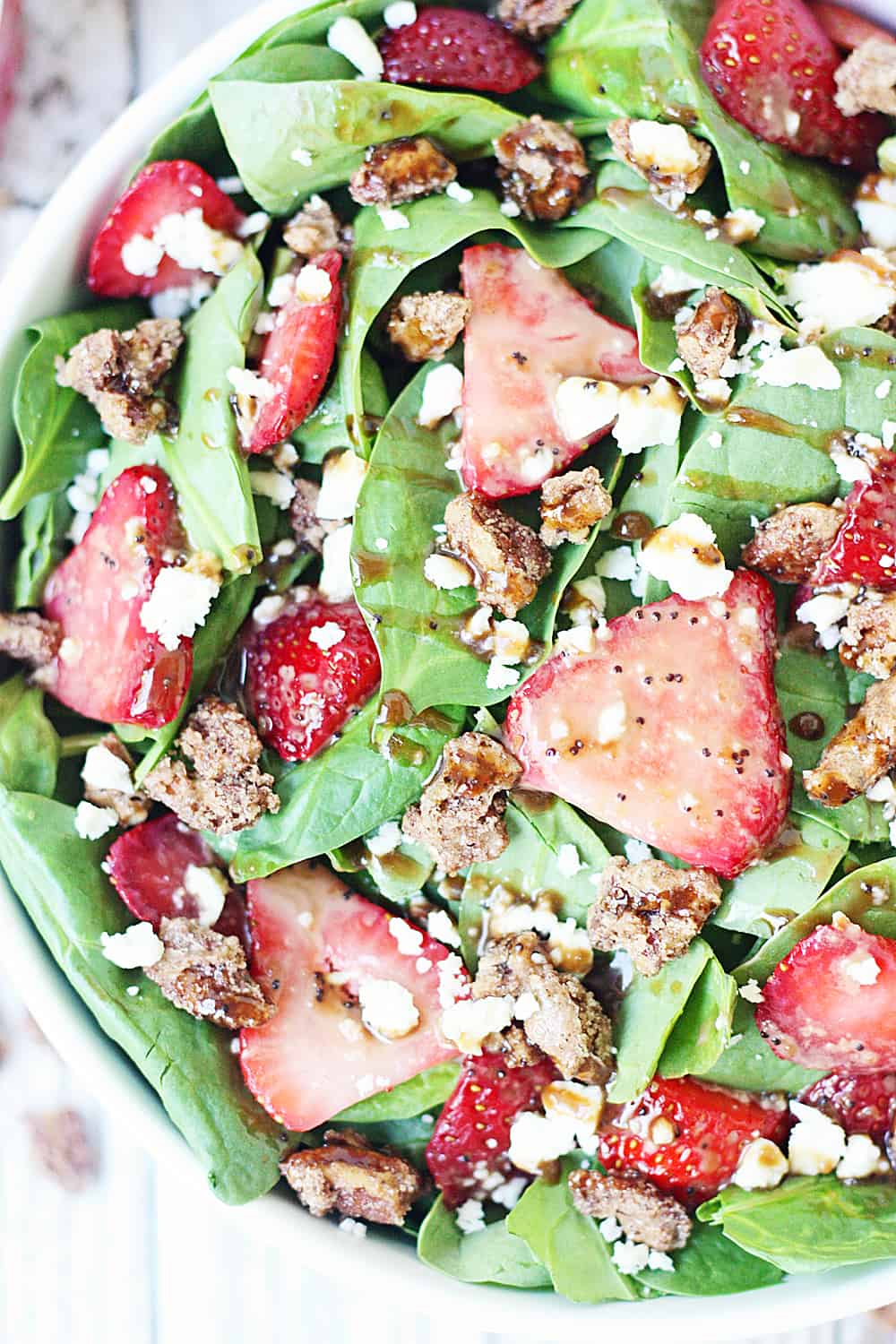 Strawberry Spinach Salad with Balsamic Poppy Seed Dressing -- This strawberry spinach salad boasts baby spinach, fresh strawberries, candied pecans, feta cheese, and the most amazing balsamic poppy seed dressing!