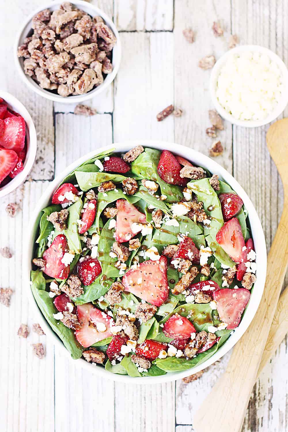 Strawberry Spinach Salad with Balsamic Poppy Seed Dressing -- This strawberry spinach salad boasts baby spinach, fresh strawberries, candied pecans, feta cheese, and the most amazing balsamic poppy seed dressing!