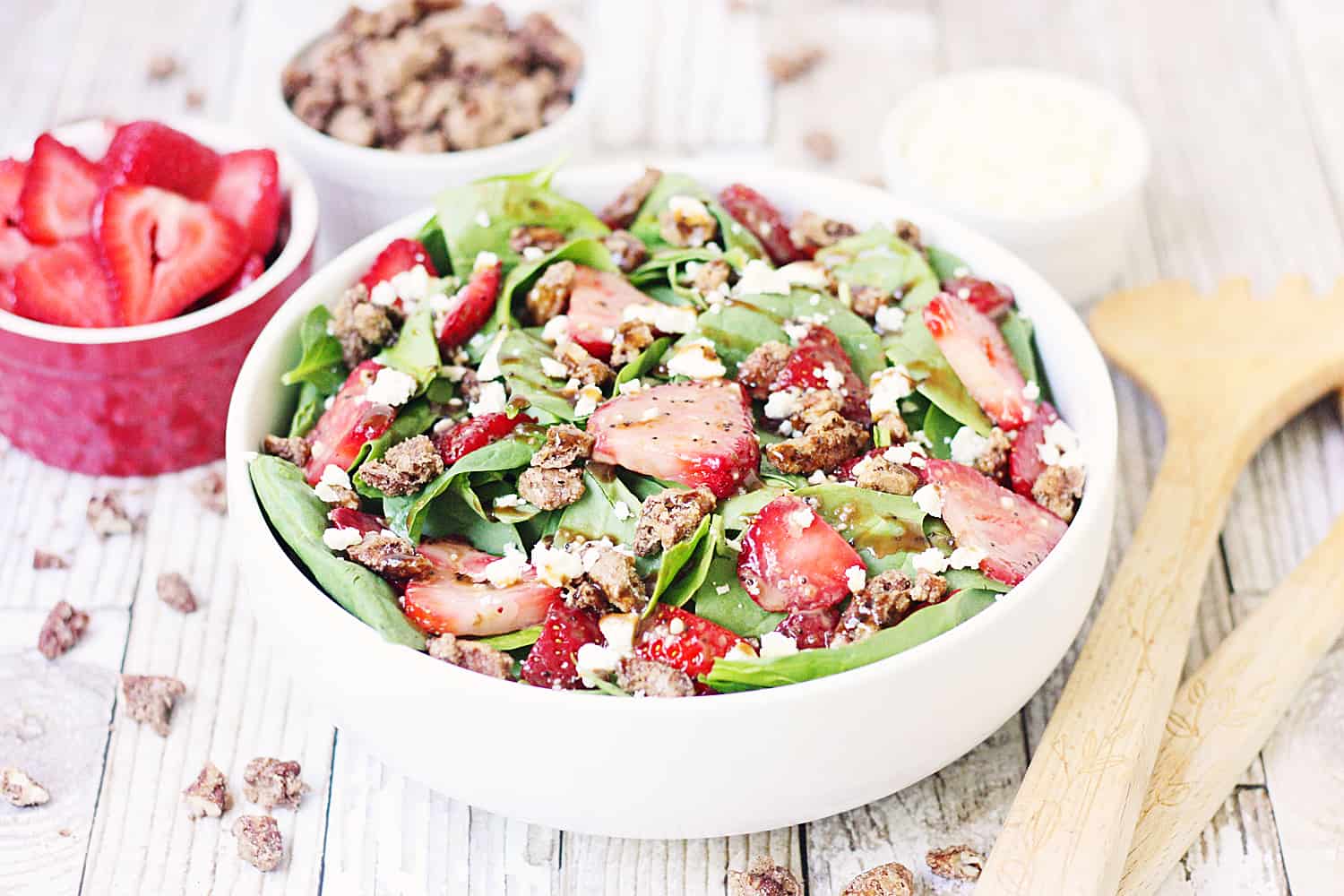 Strawberry Spinach Salad with Balsamic Poppy Seed Dressing -- This strawberry spinach salad boasts baby spinach, fresh strawberries, candied pecans, feta cheese, and the most amazing balsamic poppy seed dressing!