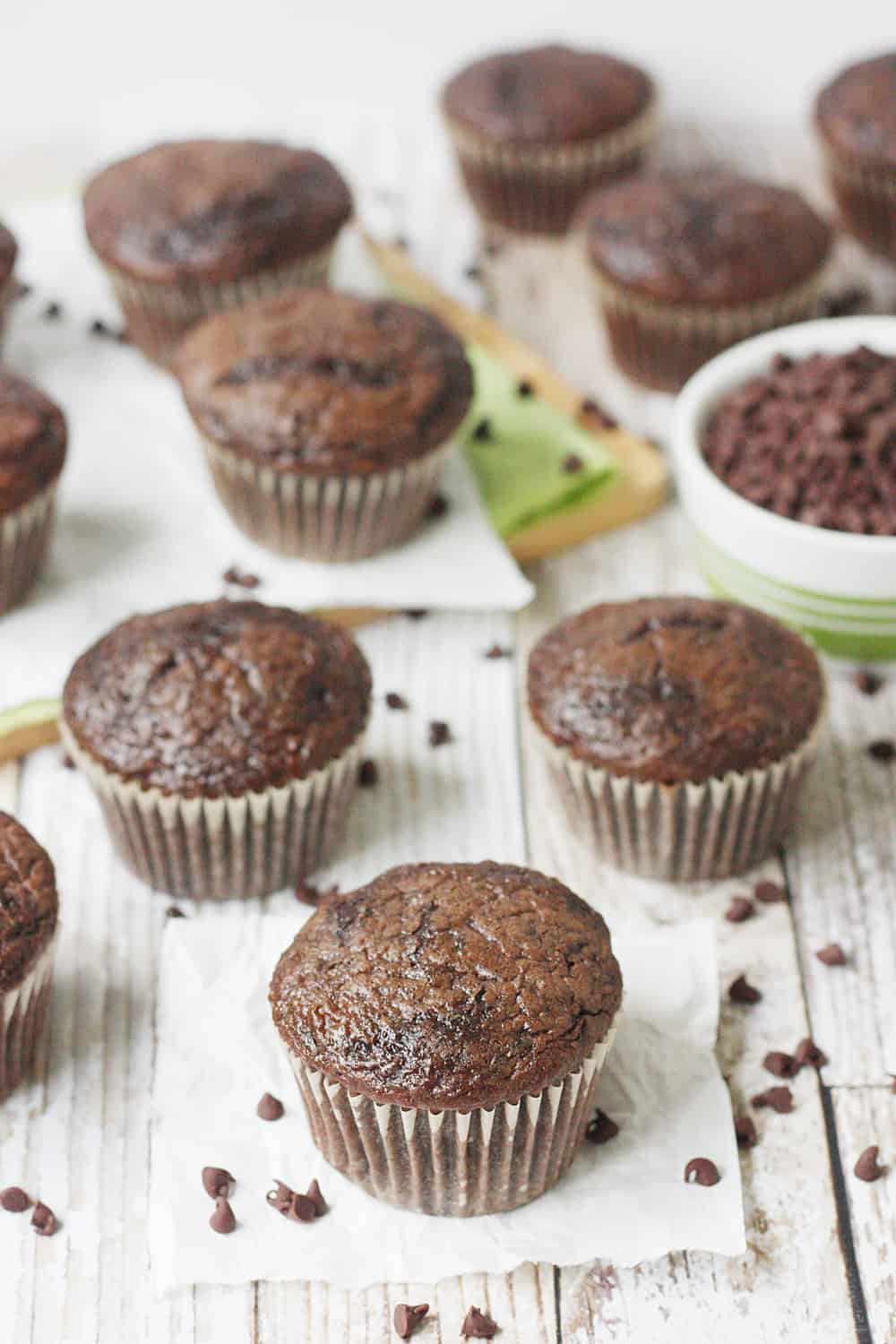 EASY Double Chocolate Zucchini Muffins on a table.