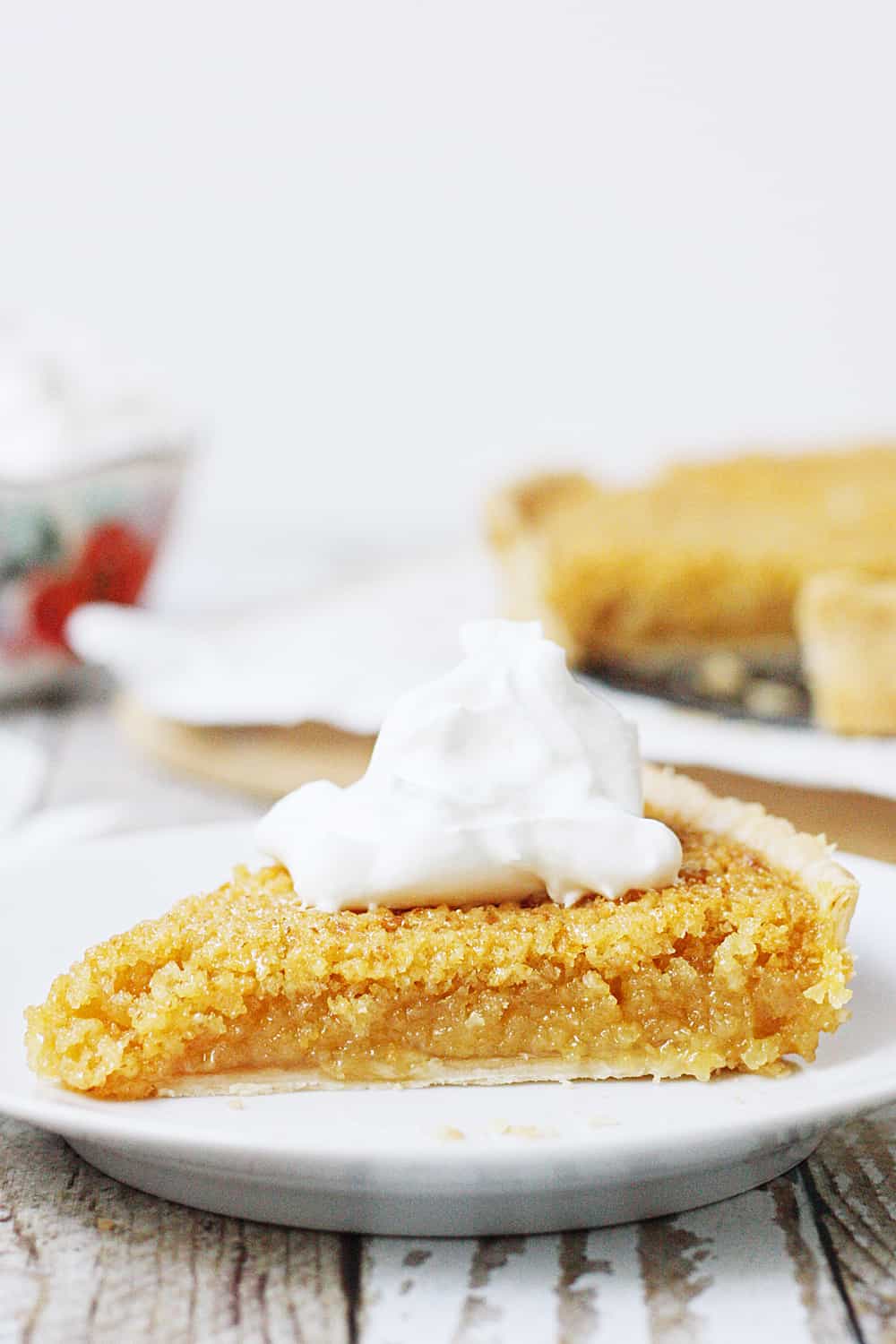EASY Treacle Tart side view with whipped cream.