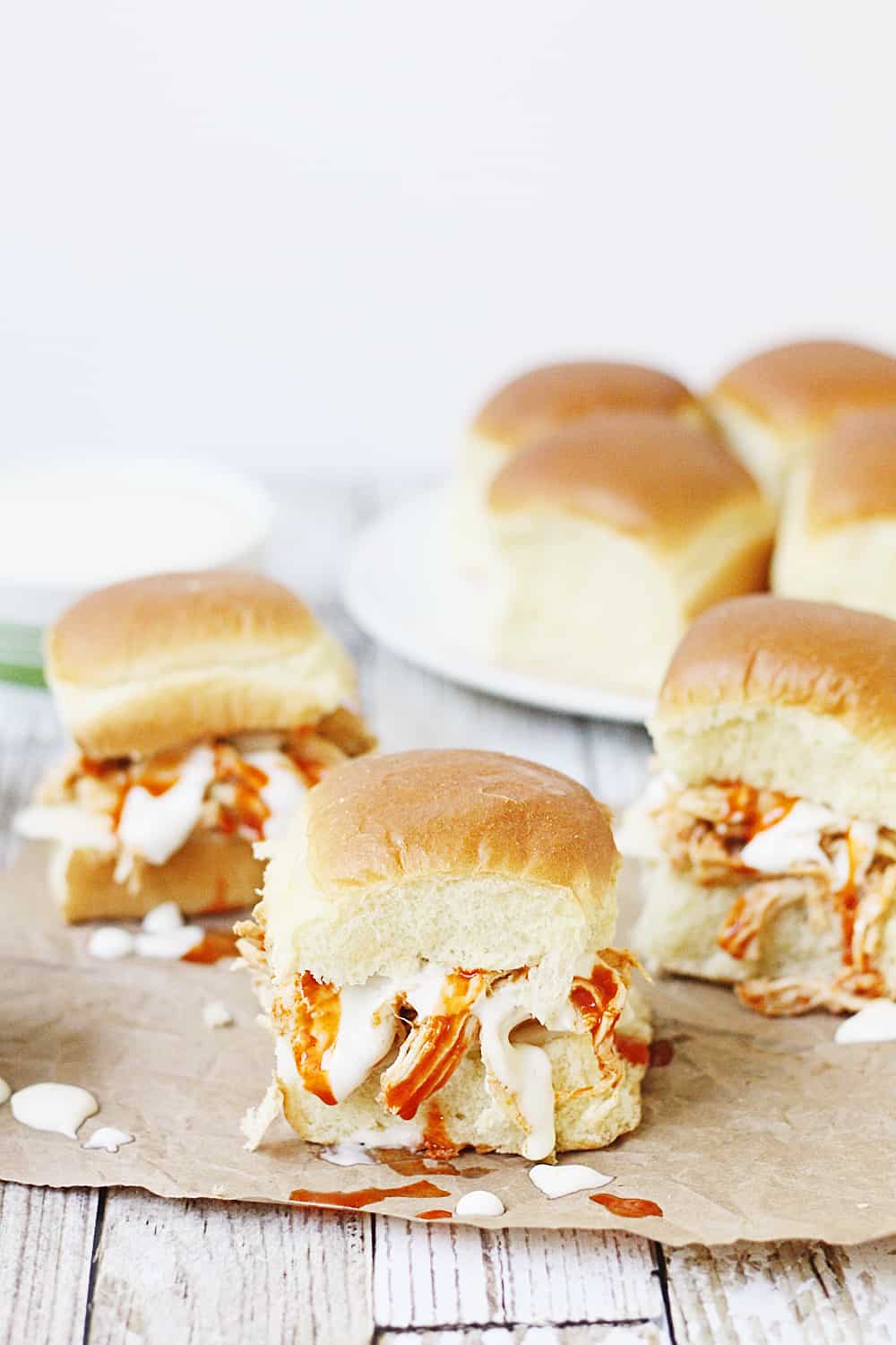 Slow Cooker Buffalo Ranch Chicken -- This slow cooker buffalo ranch chicken makes THE BEST sliders. Top with creamy blue cheese dressing and pepper jack cheese for the perfect party sandwich! #halfscratched #buffalochicken #sliders #sandwich #buffaloranch #slowcooker #crockpot #recipe #appetizer #chickensliders #chickensandwich #cooking #easyrecipe