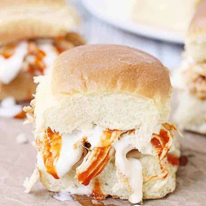 Slow Cooker Buffalo Ranch Chicken -- This slow cooker buffalo ranch chicken makes THE BEST sliders. Top with creamy blue cheese dressing and pepper jack cheese for the perfect party sandwich! #halfscratched #buffalochicken #sliders #sandwich #buffaloranch #slowcooker #crockpot #recipe #appetizer #chickensliders #chickensandwich #cooking #easyrecipe