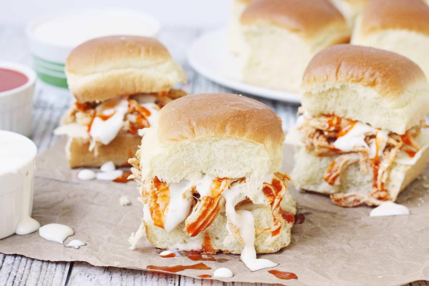 Slow Cooker Buffalo Ranch Chicken -- This slow cooker buffalo ranch chicken makes THE BEST sliders. Top with creamy blue cheese dressing and pepper jack cheese for the perfect party sandwich! #halfscratched #buffalochicken #sliders #sandwich #buffaloranch #slowcooker #crockpot #recipe #appetizer #chickensliders #chickensandwich #cooking #easyrecipe