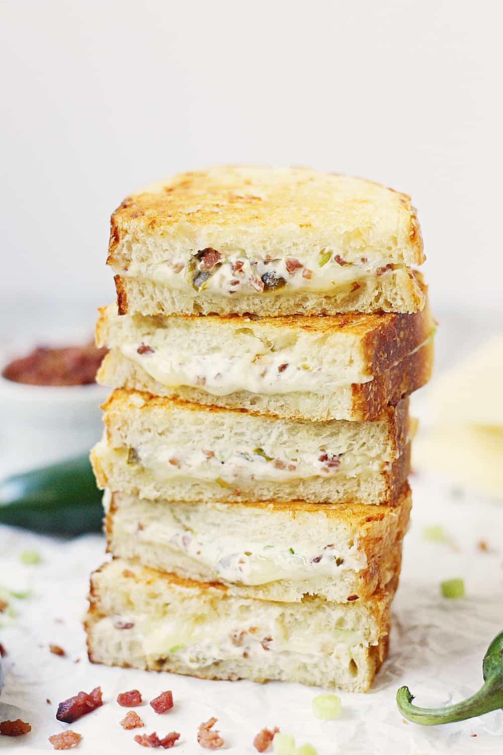 EASY Jalapeno Popper Grilled Cheese Sandwich - This easy jalapeno popper grilled cheese sandwich combines that amazing jalapeno popper flavor with bacon and sharp white cheddar for one irresistible gourmet grilled cheese! #grilledcheese #jalapeno #jalapenopopper #sandwich #grilledcheesesandwich #cheese #easyrecipe #recipe #halfscratched #maindish #savory