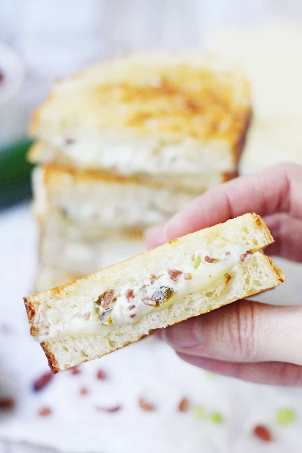 EASY Jalapeno Popper Grilled Cheese Sandwich - This easy jalapeno popper grilled cheese sandwich combines that amazing jalapeno popper flavor with bacon and sharp white cheddar for one irresistible gourmet grilled cheese! #grilledcheese #jalapeno #jalapenopopper #sandwich #grilledcheesesandwich #cheese #easyrecipe #recipe #halfscratched #maindish #savory