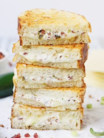 EASY Jalapeno Popper Grilled Cheese Sandwich - This easy jalapeno popper grilled cheese sandwich combines that amazing jalapeño popper flavor with bacon and sharp white cheddar for one irresistible gourmet grilled cheese! #grilledcheese #jalapeno #jalapenopopper #sandwich #grilledcheesesandwich #cheese #easyrecipe #recipe #halfscratched #maindish #savory