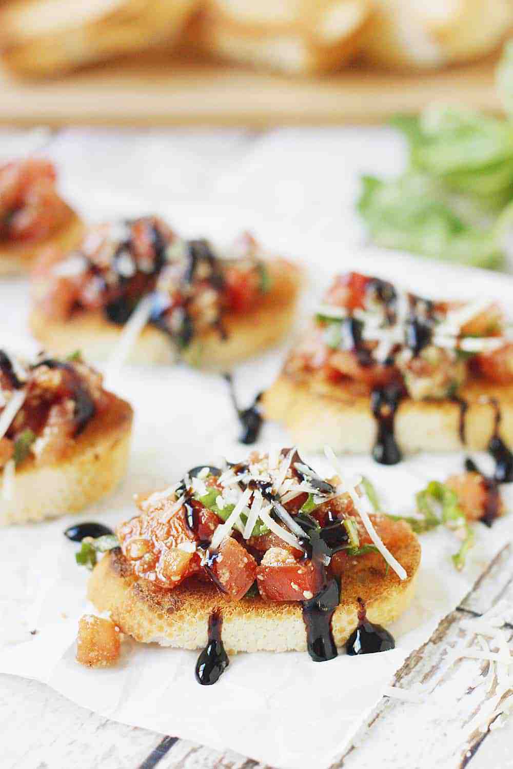 Easy Tomato Bruschetta Recipe - Top toasted baguette slices with this easy tomato bruschetta for an appetizer full of tomato, basil, balsamic flavor that is perfect for holiday parties! #bruschetta #tomato #halfscratched #appetizer #tomatobruschetta #cooking #baking #easyrecipe #holidayrecipe