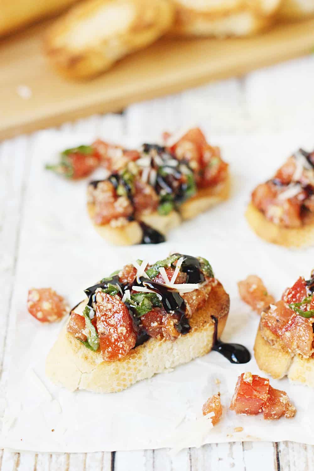 Easy Tomato Bruschetta Recipe - Top toasted baguette slices with this easy tomato bruschetta for an appetizer full of tomato, basil, balsamic flavor that is perfect for holiday parties! #bruschetta #tomato #halfscratched #appetizer #tomatobruschetta #cooking #baking #easyrecipe #holidayrecipe