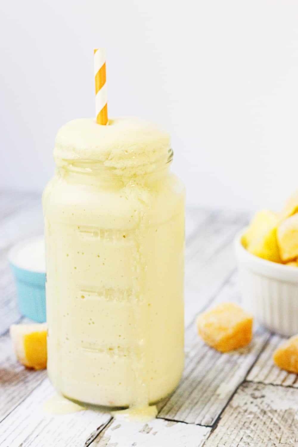 Easy Mango Protein Smoothie side with a straw.