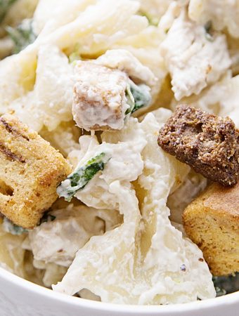 Best Bowtie Chicken Caesar Salad - There's chicken Caesar salad and there's chicken Caesar pasta salad. Once you add bowtie pasta to Caesar salad, you won't want to eat it any other way! #caesarsalad #bowtie #pastasalad #pasta #salad #halfscratched #easyrecipe #sidedish