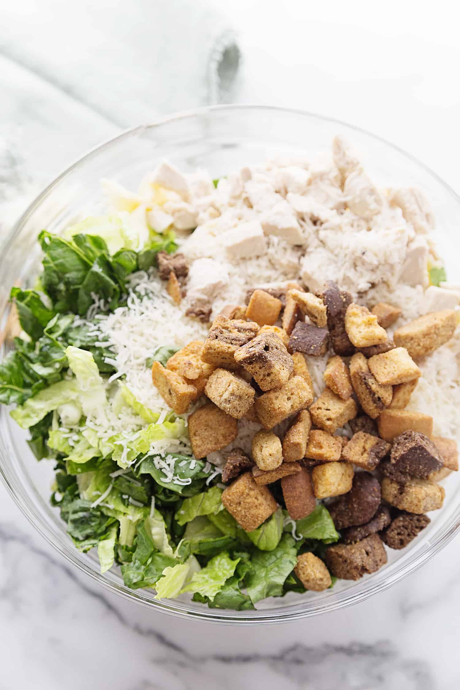 Best Bowtie Chicken Caesar Salad - There's chicken Caesar salad and there's chicken Caesar pasta salad. Once you add bowtie pasta to Caesar salad, you won't want to eat it any other way! #caesarsalad #bowtie #pastasalad #pasta #salad #halfscratched #easyrecipe #sidedish