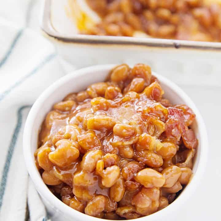 Homemade Baked Beans -- Looking for the best homemade baked beans recipe? This is it! A handful of ingredients plus a half hour in the oven equals the yummiest, most crowd-pleasing baked beans from scratch! #halfscratched #bakedbeans #beans #sidedish #savory #bacon #lentils #easyrecipe
