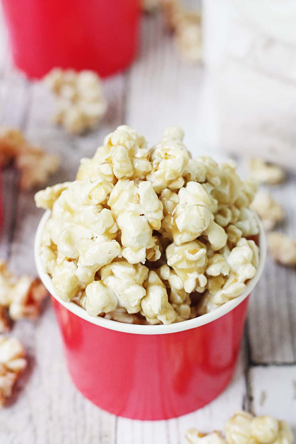 Easy Caramel Popcorn - Who doesn't love a quick, delicious, easy caramel popcorn recipe? The first time you try this easy homemade caramel popcorn, you'll be hooked! #popcorn #caramelpopcorn #halfscratched #caramel #dessert #easyrecipe #sweet