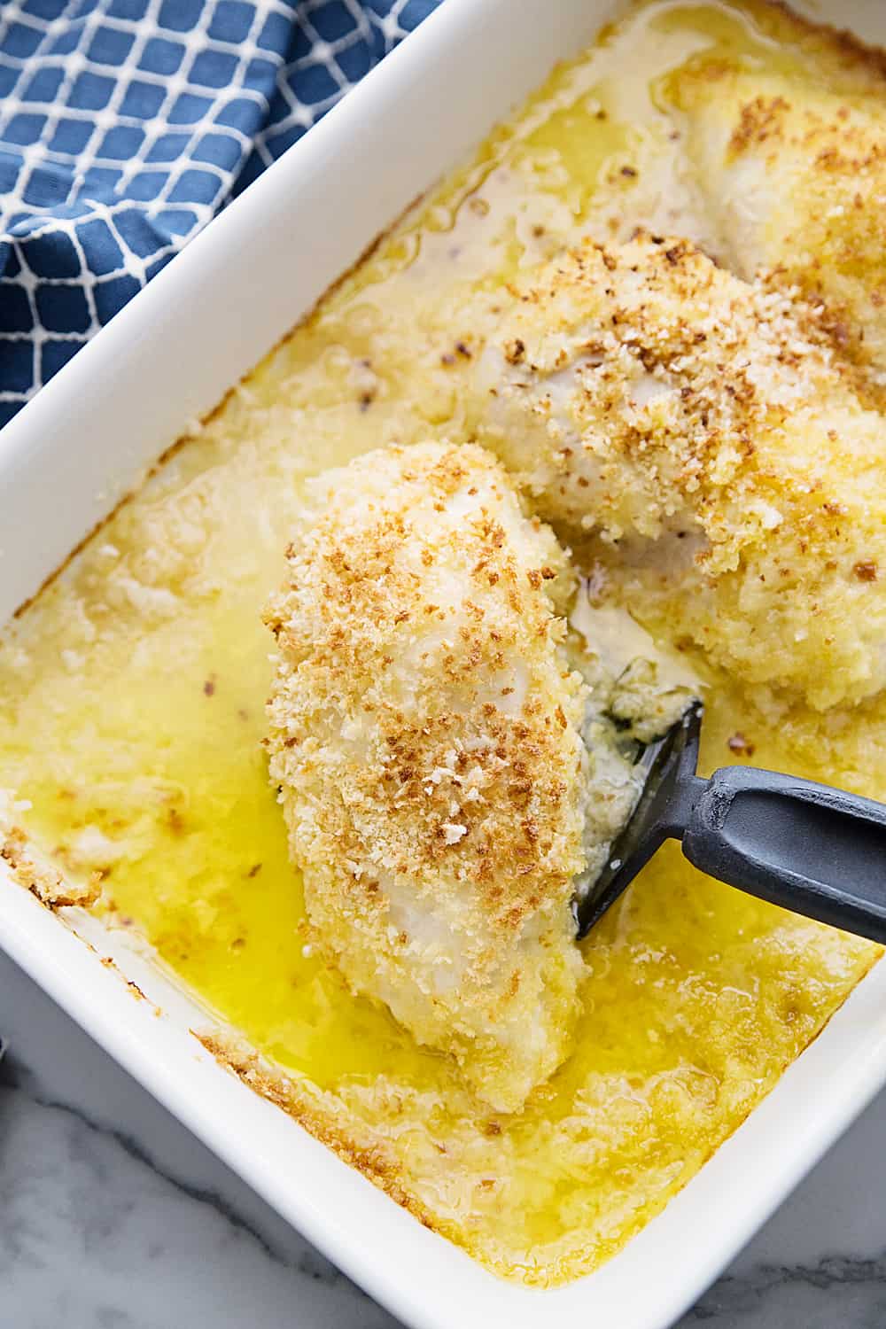 Easy Swiss Cheese Chicken - This Swiss cheese chicken recipe is an easy weeknight meal! Chicken breasts are covered in a creamy sauce and cheese and topped with crispy bread crumbs.