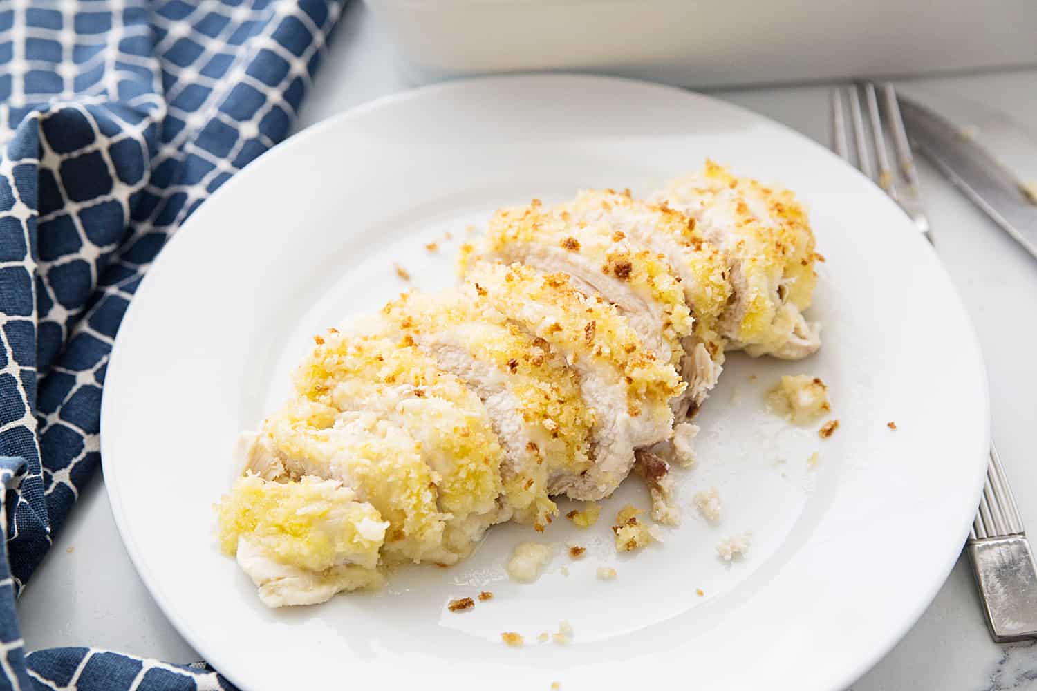 Easy Swiss Cheese Chicken - This Swiss cheese chicken recipe is an easy weeknight meal! Chicken breasts are covered in a creamy sauce and cheese and topped with crispy bread crumbs.