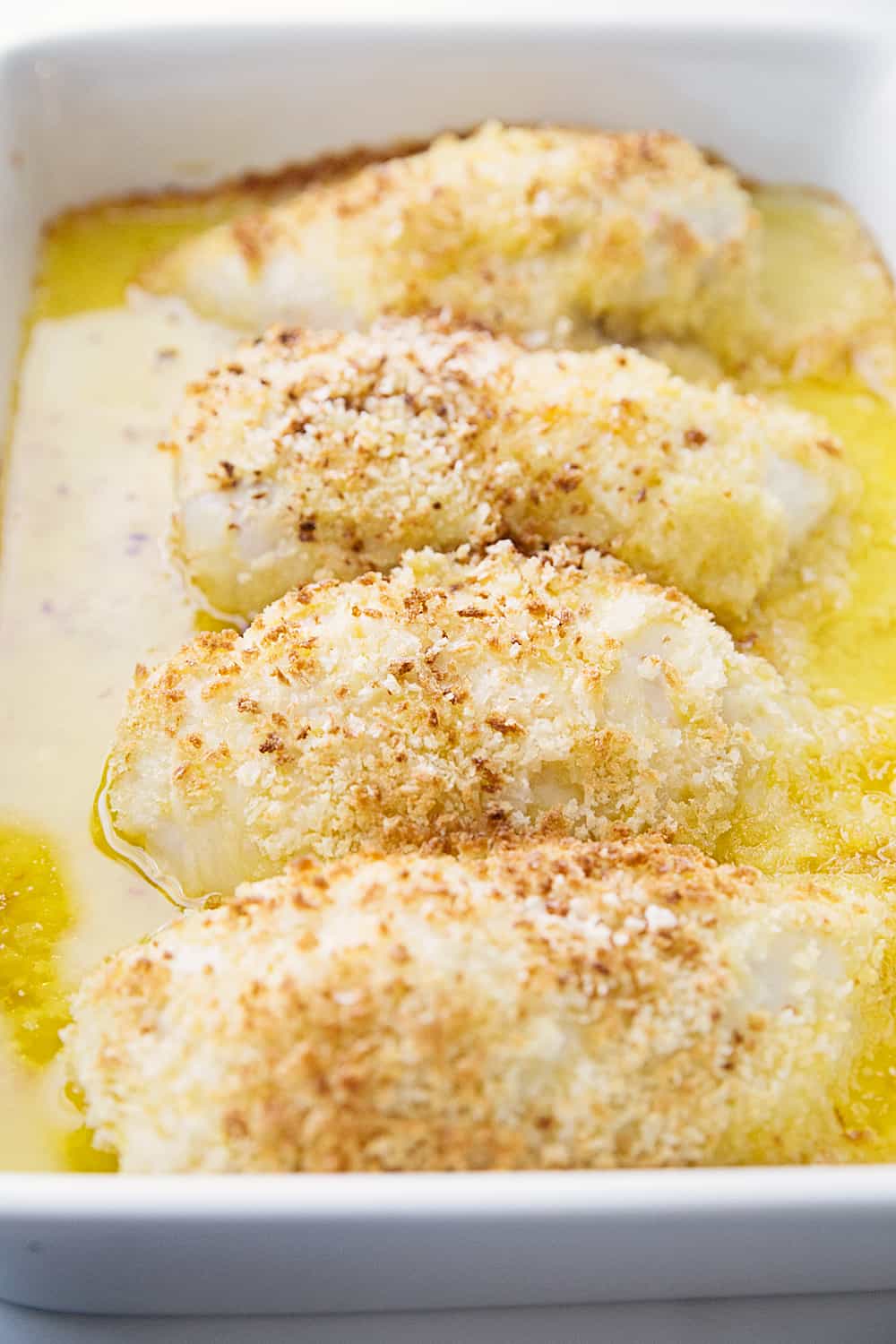 Easy Swiss Cheese Chicken - This Swiss cheese chicken recipe is an easy weeknight meal! Chicken breasts are covered in a creamy sauce and cheese and topped with crispy bread crumbs.