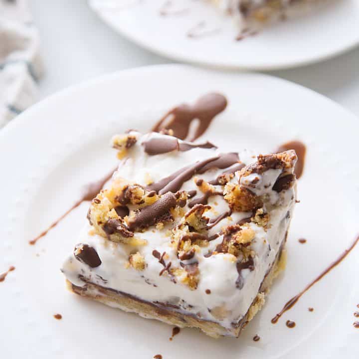 Chocolate Chip Cookie Ice Cream Cake -- Impress guests and taste buds with this chocolate chip cookie ice cream cake. So many layers of scrumptious flavors--what's not to love? #icecream #cookie #icecreamcake #dessert #easydessert #dessertrecipe #chocolatechipcookie #halfscratched #baking