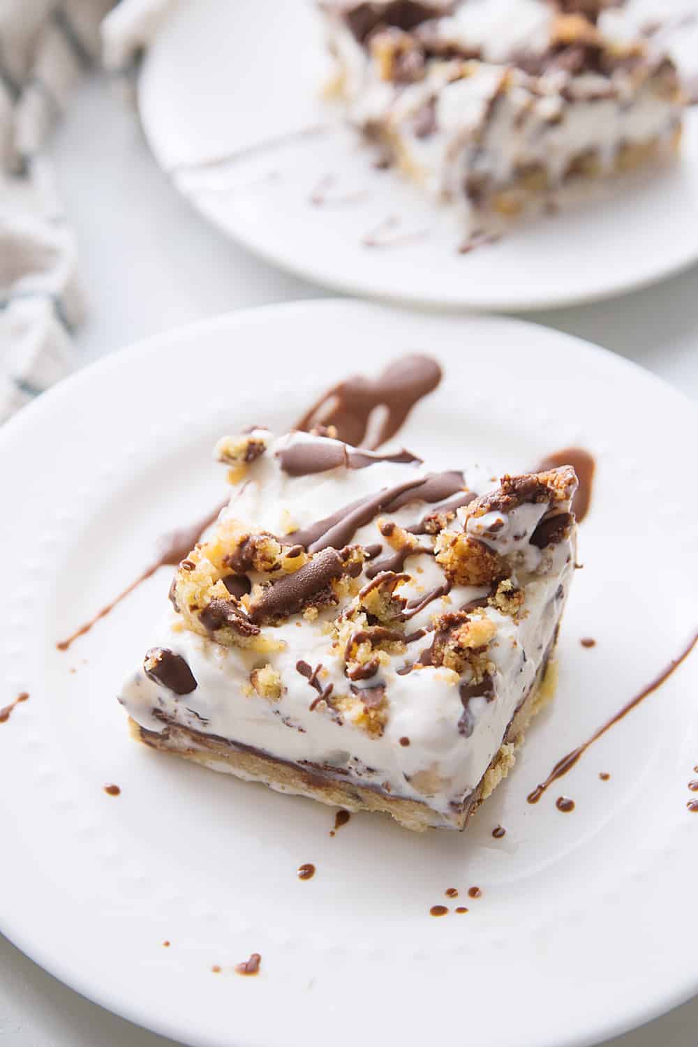 Chocolate Chip Cookie Ice Cream Cake -- Impress guests and taste buds with this chocolate chip cookie ice cream cake. So many layers of scrumptious flavors&Mdash;what's not to love? #icecream #cookie #icecreamcake #dessert #easydessert #dessertrecipe #chocolatechipcookie #halfscratched #baking
