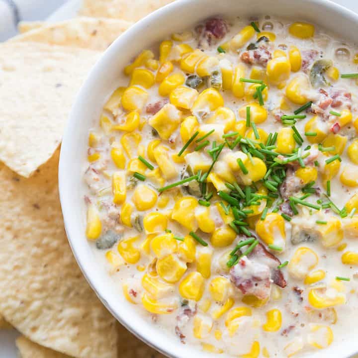 Slow Cooker Cheesy Hot Corn Dip - Looking for a game day appetizer that will have family, friends, and fans cheering? Serve a slow cooker full of this cheesy hot corn dip! #appetizer #slowcooker #crockpot #recipe #corndip #hotcorndip #halfscratched #slowcookerrecipe #crockpotrecipe #appetizerrecipe