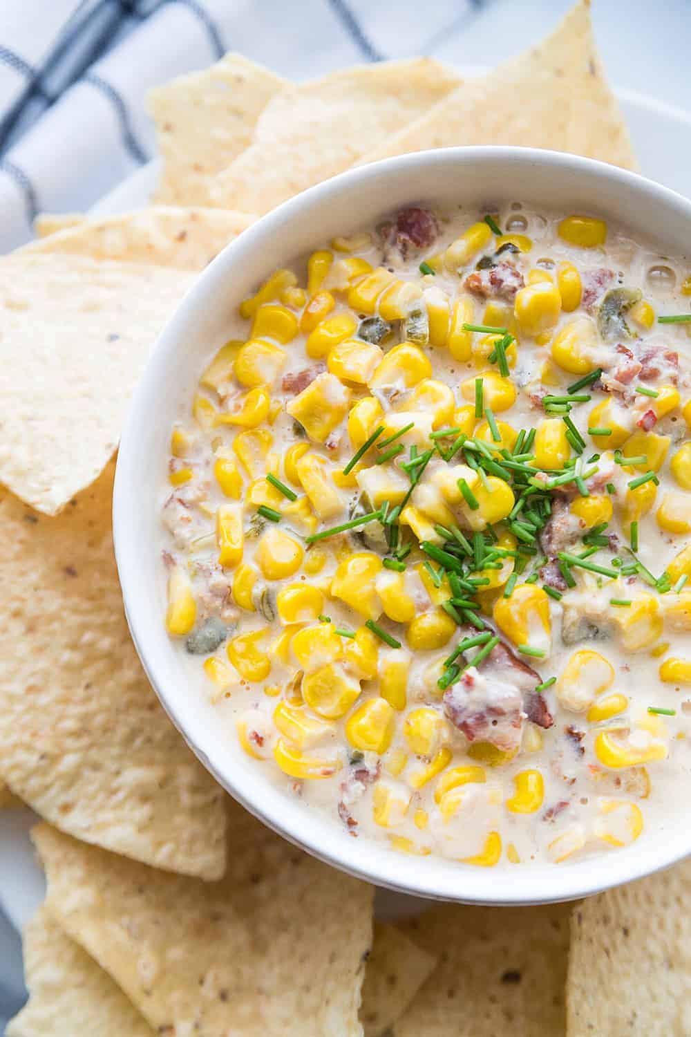 Slow Cooker Cheesy Hot Corn Dip - Looking for a game day appetizer that will have family, friends, and fans cheering? Serve a slow cooker full of this cheesy hot corn dip! #appetizer #slowcooker #crockpot #recipe #corndip #hotcorndip #halfscratched #slowcookerrecipe #crockpotrecipe #appetizerrecipe