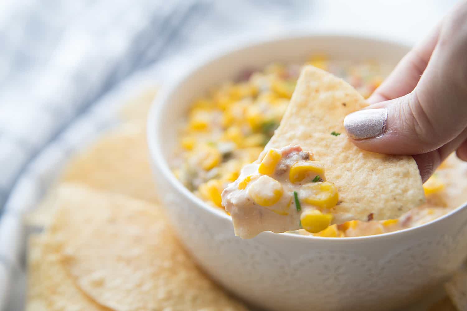 Slow Cooker Cheesy Hot Corn Dip - Looking for a game day appetizer that will have family, friends, and fans cheering? Serve a slow cooker full of this cheesy hot corn dip! #appetizer #slowcooker #crockpot #recipe #corndip #hotcorndip #halfscratched #slowcookerrecipe #crockpotrecipe #appetizerrecipe