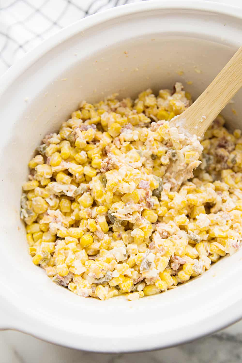 Slow Cooker Cheesy Hot Corn Dip - Looking for a game day appetizer that will have family, friends, and fans cheering? Serve a slow cooker full of this cheesy hot corn dip! #appetizer #slowcooker #crockpot #recipe #corndip #hotcorndip #halfscratched #slowcookerrecipe #crockpotrecipe #appetizerrecipe
