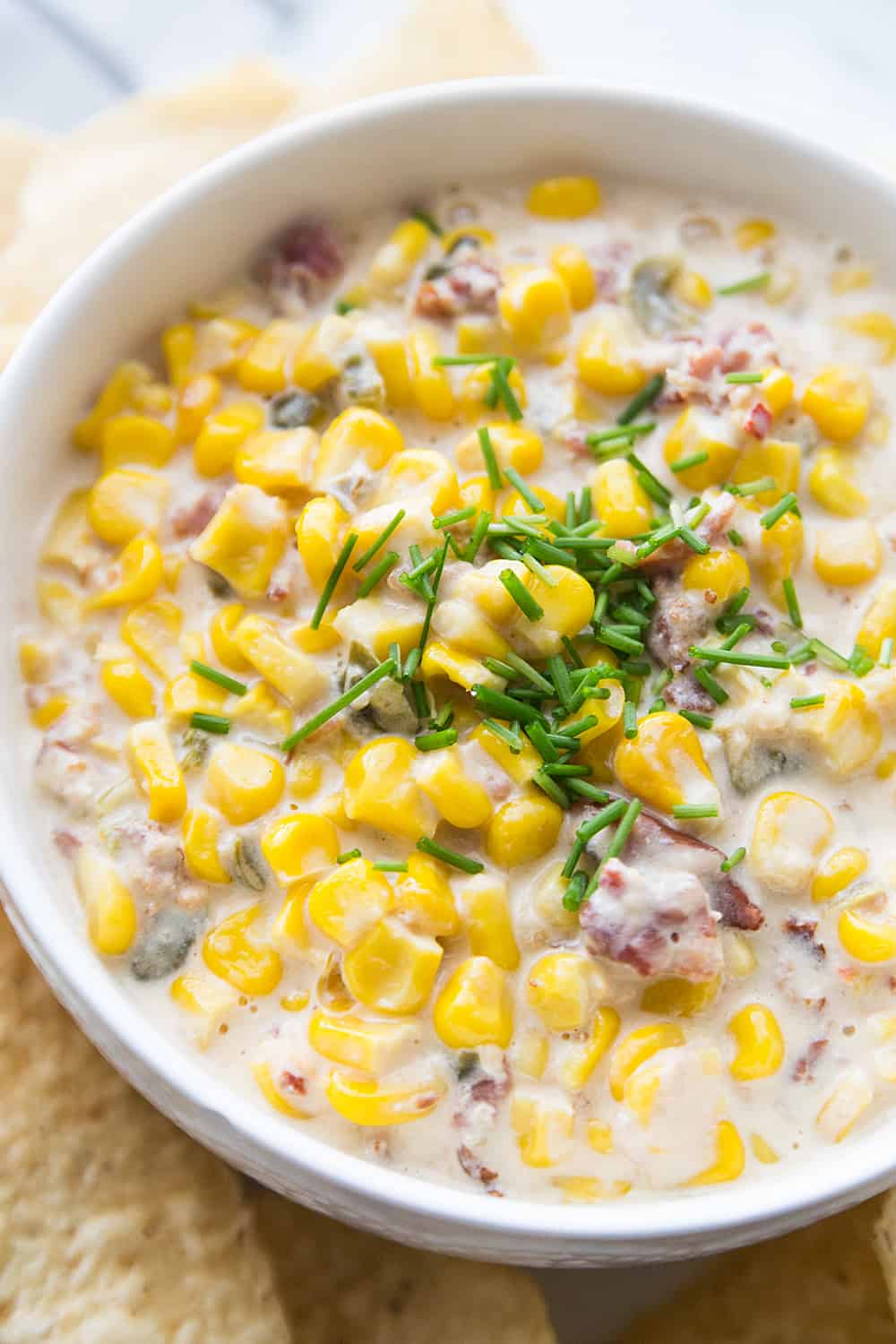 Slow Cooker Cheesy Hot Corn Dip - Looking for a game day appetizer that will have family, friends, and fans cheering? Serve a slow cooker full of this cheesy hot corn dip! #appetizer #slowcooker #crockpot #recipe #corndip #hotcorndip #halfscratched #slowcookerrecipe #crockpotrecipe #appetizerrecipe
