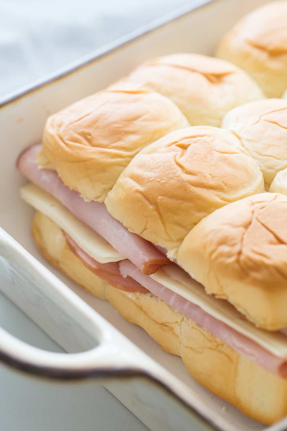 Hawaiian Ham & Cheese Sliders - Need a tasty way to use leftover ham or a recipe that'll feed a crowd? Look no further than Hawaiian ham and cheese sliders!