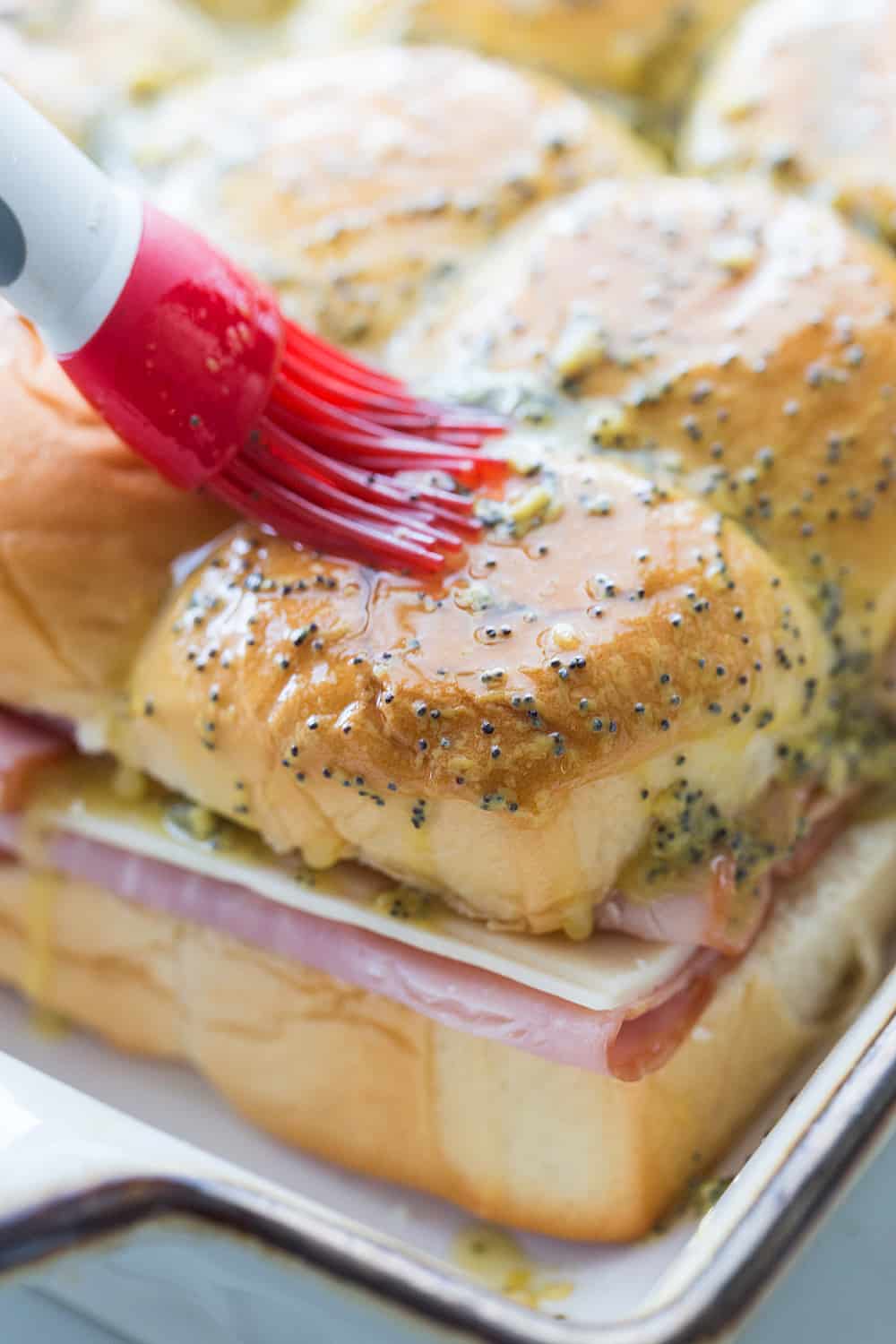 Hawaiian Ham & Cheese Sliders - Need a tasty way to use leftover ham or a recipe that'll feed a crowd? Look no further than Hawaiian ham and cheese sliders!