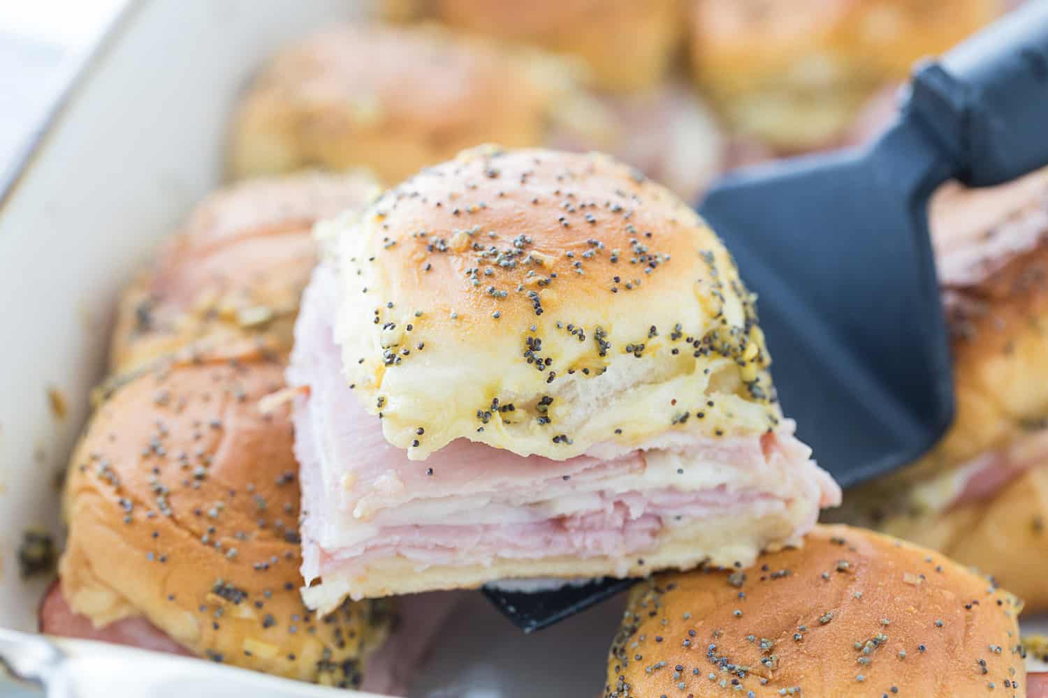 Hawaiian Ham & Cheese Sliders - Need a tasty way to use leftover ham or a recipe that'll feed a crowd? Look no further than Hawaiian ham and cheese sliders!