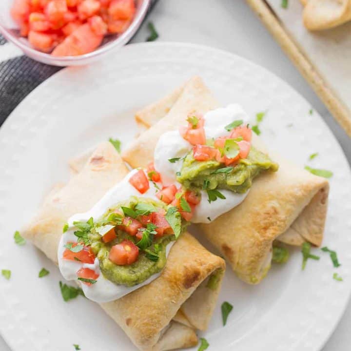 Baked Chicken Chimichangas - Baked chicken chimichangas make for a fun, flavorful alternative to tacos for Taco Tuesday. They're also a super tasty freezer meal! #mexicanrecipe #mexicanfood #chimichangas #easyrecipe #freezermeal #freezerrecipe #halfscratched #tacotuesday