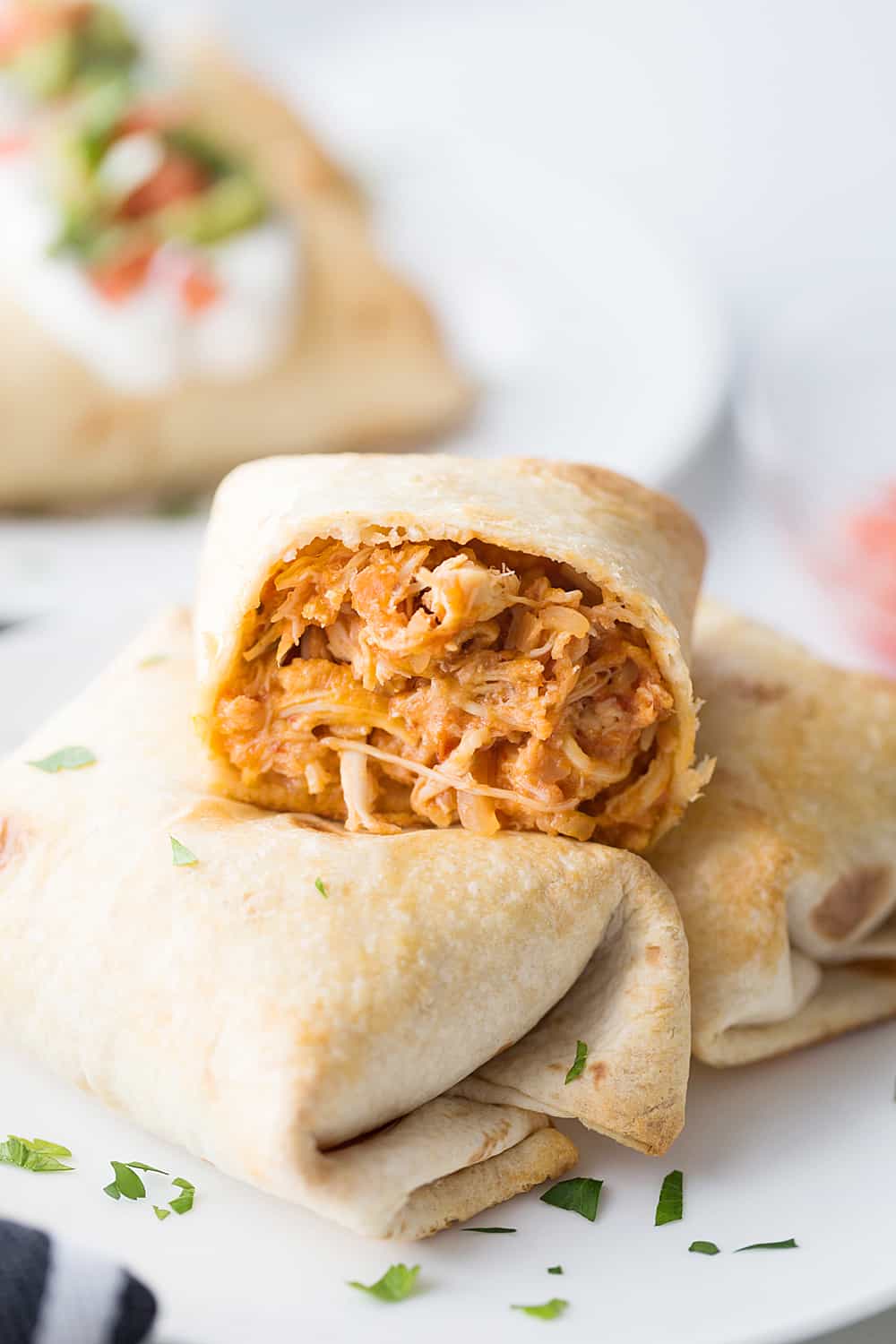 Baked Chicken Chimichangas - Baked chicken chimichangas make for a fun, flavorful alternative to tacos for Taco Tuesday. They're also a super tasty freezer meal! #mexicanrecipe #mexicanfood #chimichangas #easyrecipe #freezermeal #freezerrecipe #halfscratched #tacotuesday