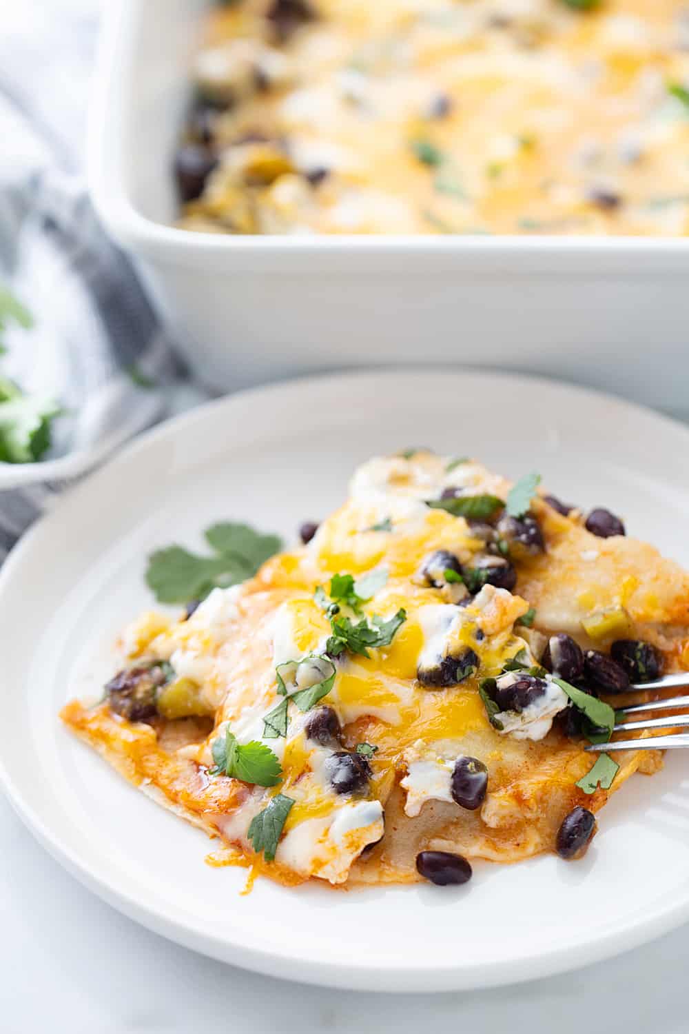 Layered Black Bean Enchiladas - When you don't have the time for classic chicken enchiladas, try these layered black bean enchilads. Quick, easy, and delicious! #enchiladas #mexicanrecipe #mexicanfood #blackbean #halfscratched #tacotuesday #easyrecipe #enchilada