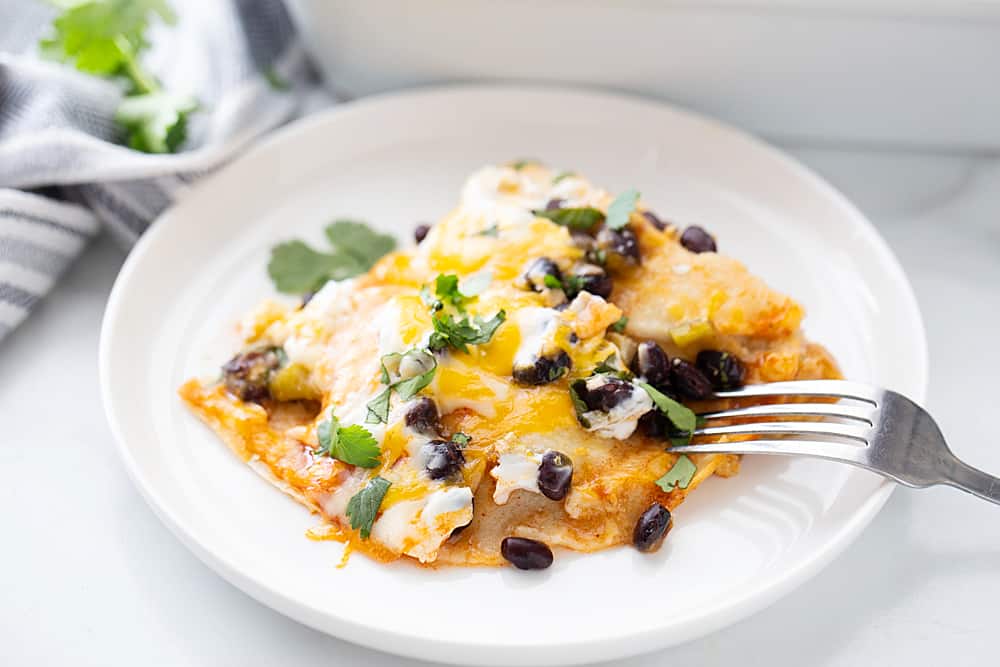 Layered Black Bean Enchiladas - When you don't have the time for classic chicken enchiladas, try these layered black bean enchilads. Quick, easy, and delicious! #enchiladas #mexicanrecipe #mexicanfood #blackbean #halfscratched #tacotuesday #easyrecipe #enchilada